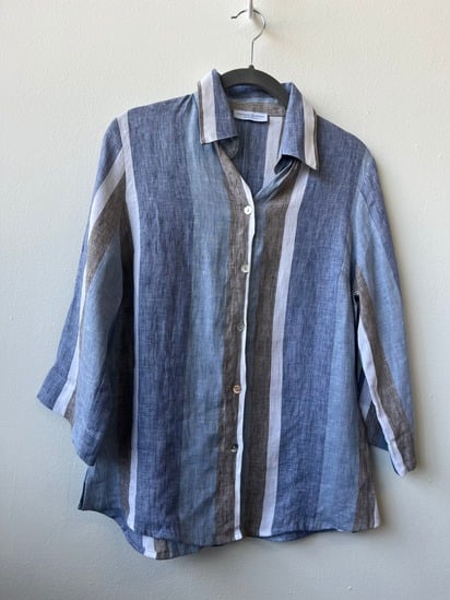 Vintage blue and white striped linen button-up shirt on a hanger