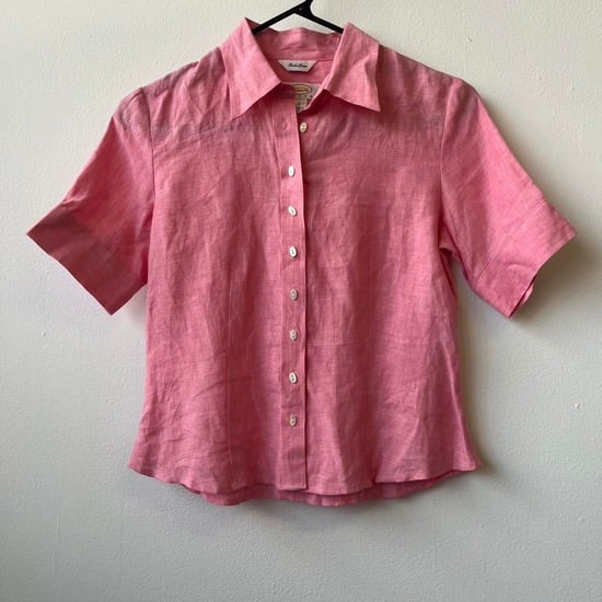 Vintage pink linen short-sleeve button-up shirt on a hanger
